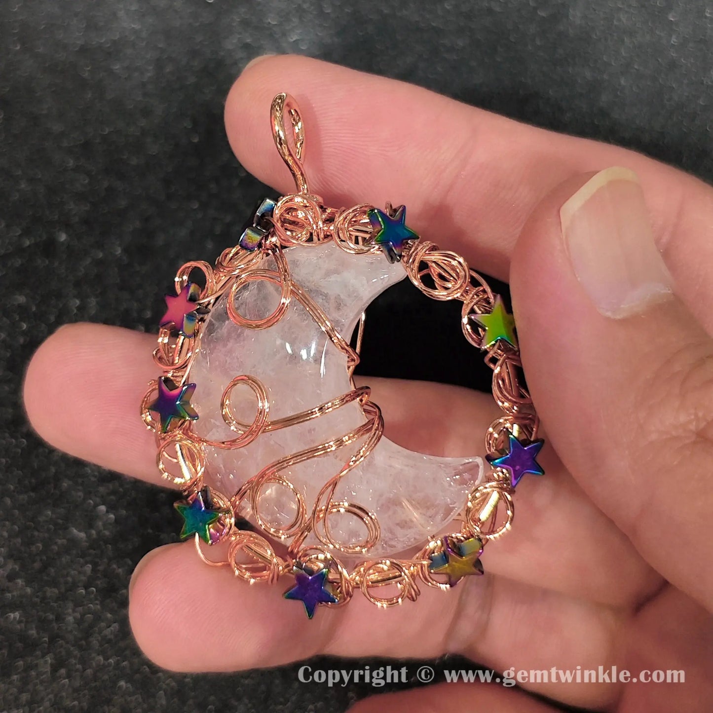 Handheld preview of 50mm celestial wire wrapped quartz crescent moon pendant with rainbow stars