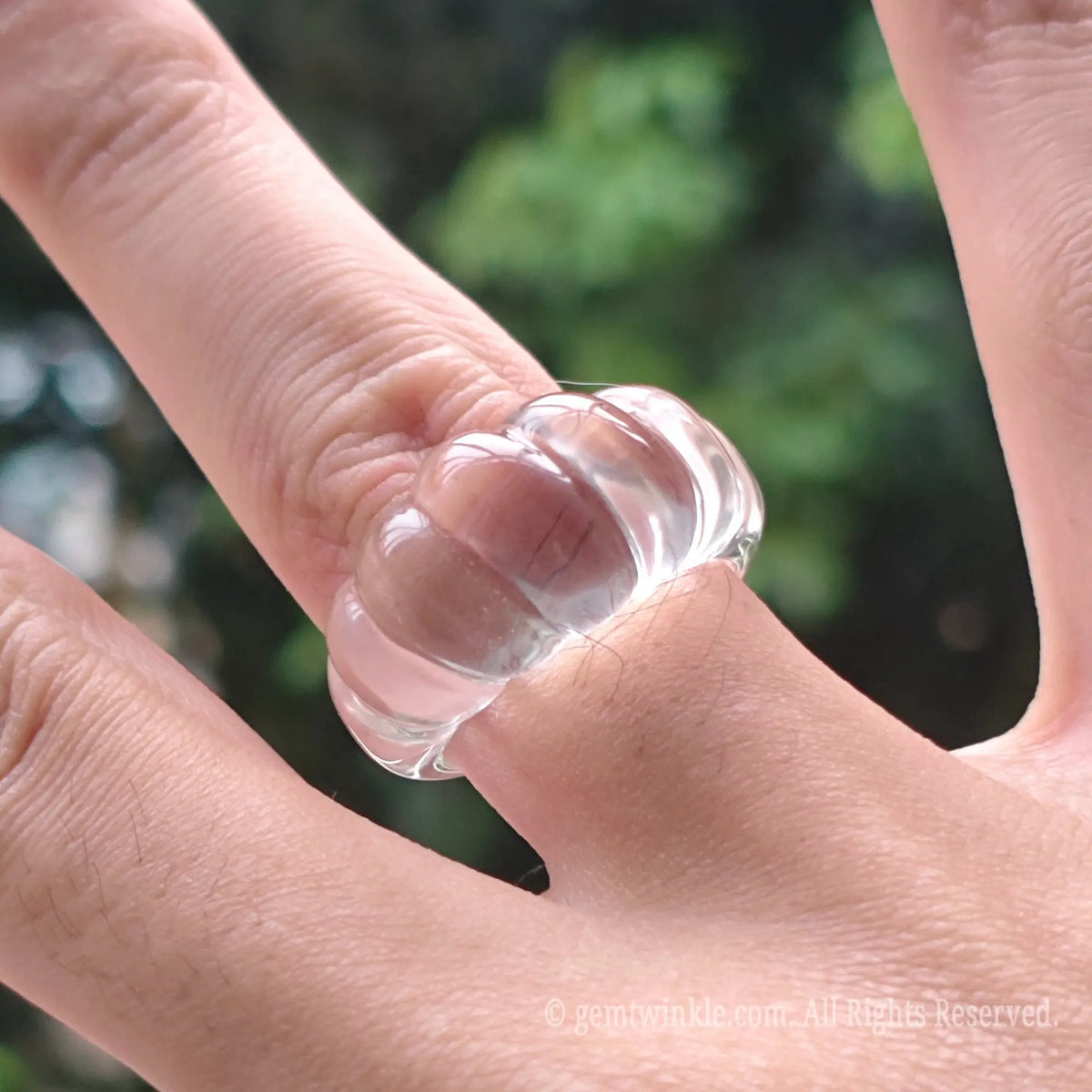 Natural clear quartz carved pumpkin band ring styled on finger displaying vintage fashion jewelry look