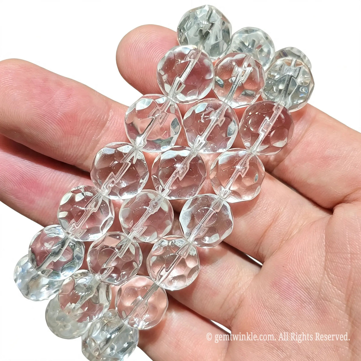 Natural Clear Quartz has a Mohs hardness of 7, making it durable for daily wear. To protect the elastic stretch cord and maintain facet brilliance, avoid wearing the bracelet while swimming, showering, or exercising. Keep away from harsh household chemicals, perfumes, and abrasive surfaces that could scuff the polished facets. Clean gently with a soft dry microfiber cloth to restore crystal sparkle. Store flat in a soft fabric pouch when not in use.
