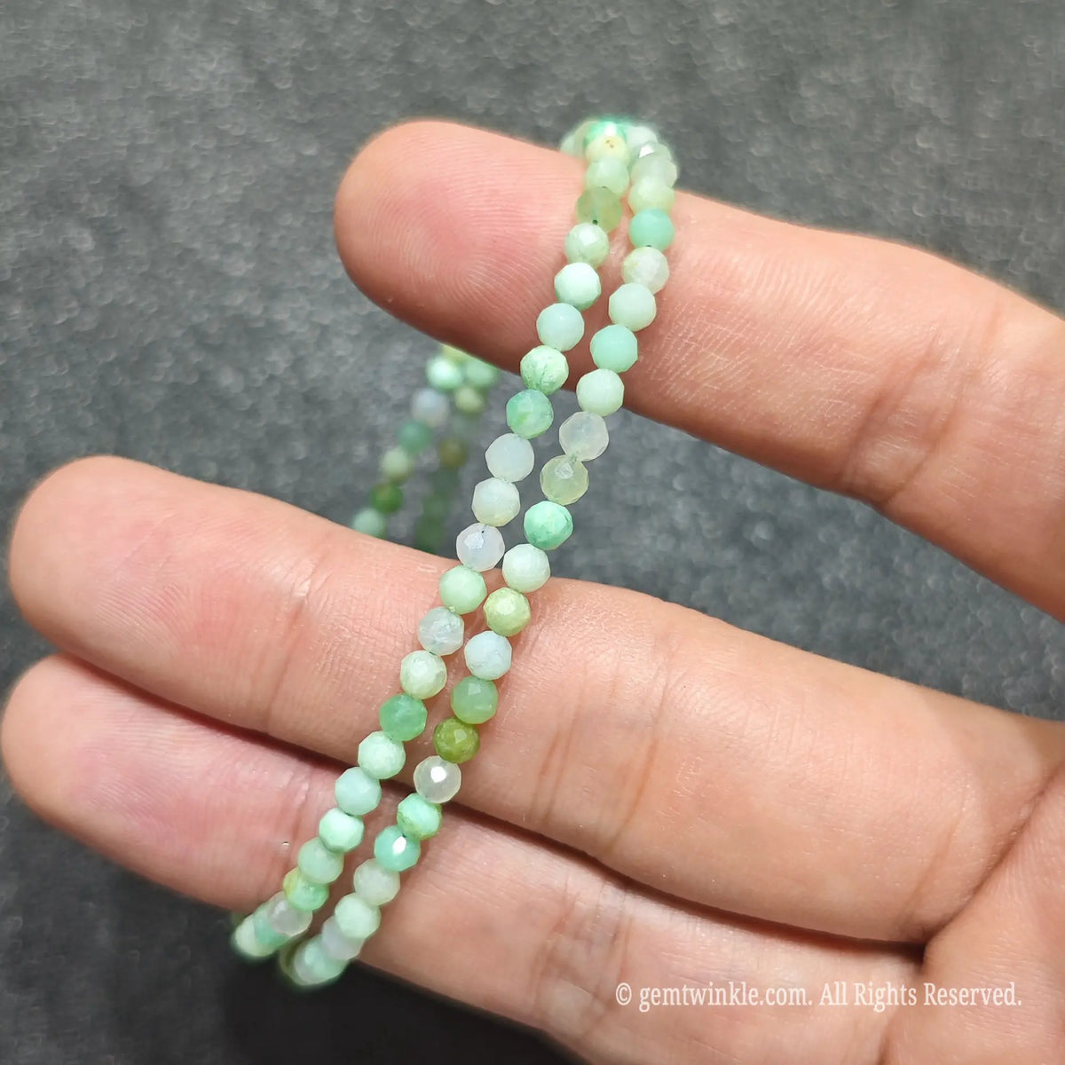 Chrysoprase is a durable chalcedony quartz with a Mohs hardness of 6.5 to 7. To prevent long-term color fading, avoid prolonged exposure to direct high heat or intense sunlight. Clean gently with warm water, mild soap, and a soft microfiber cloth. Avoid harsh acidic chemicals or steam cleaning, and remove before swimming to safeguard the gold-plated metal clasp.