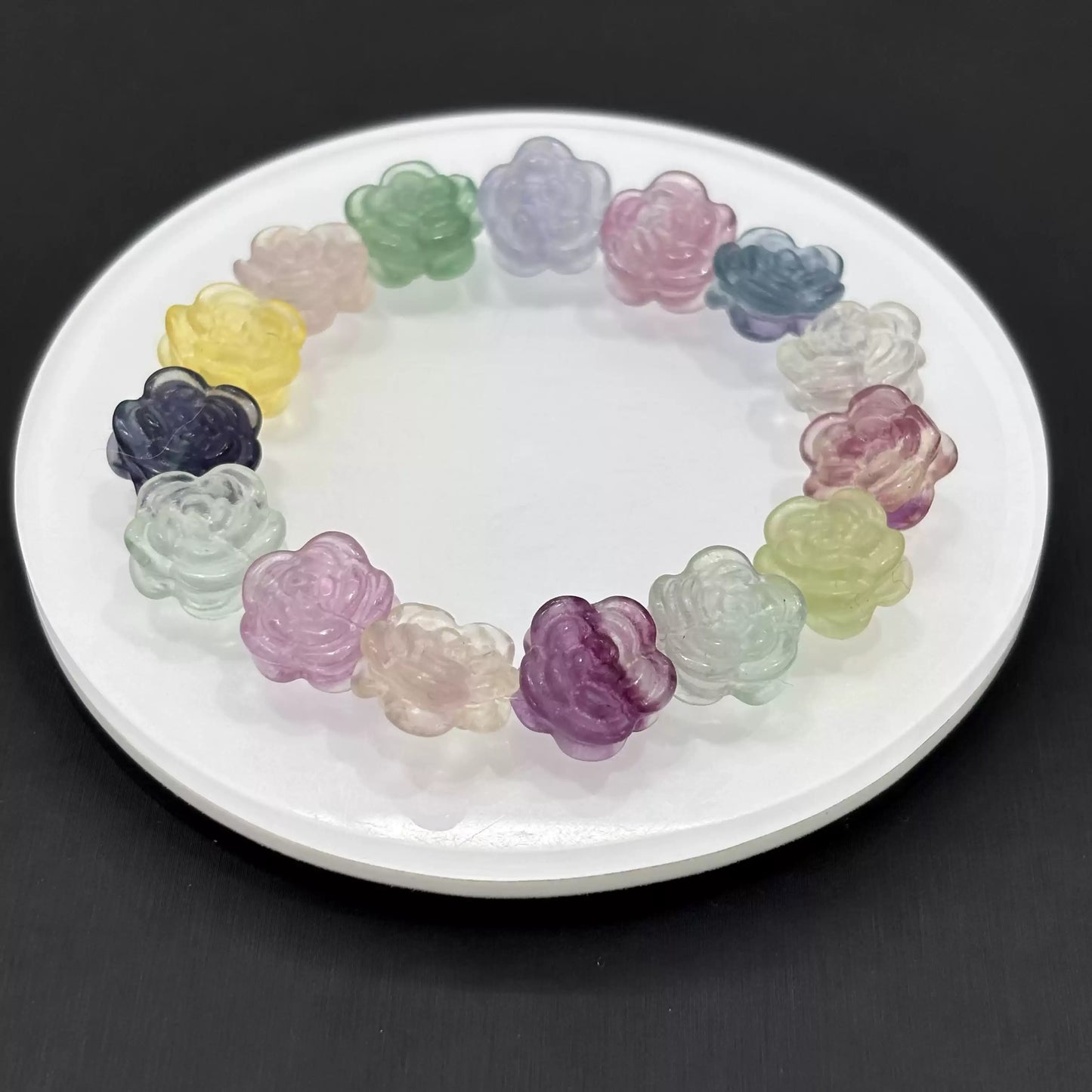 Clean presentation: fluorite flower beads strung with clear faceted spacers on elastic cord—no metal components