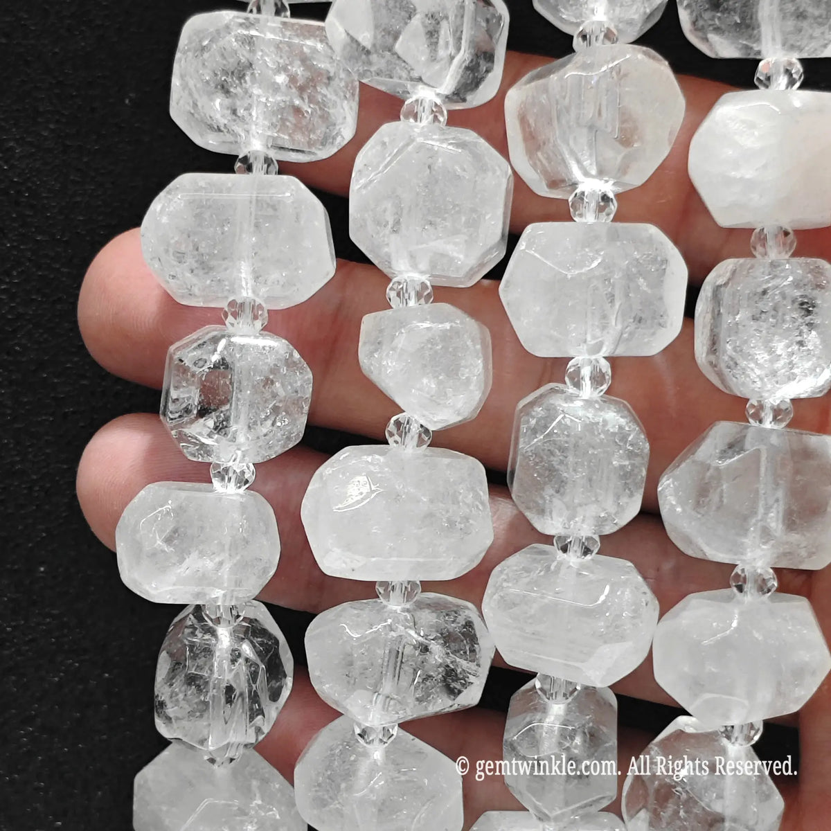 Close up of multiple strands of natural freeform milky white quartz pebble beads for handmade jewelry supplies
