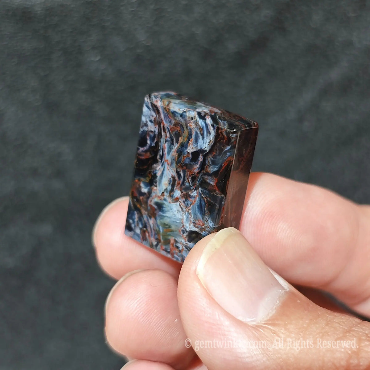 Top down angle view of natural petersite rectangular gemstone designed for wire wrapping and metalsmithing
