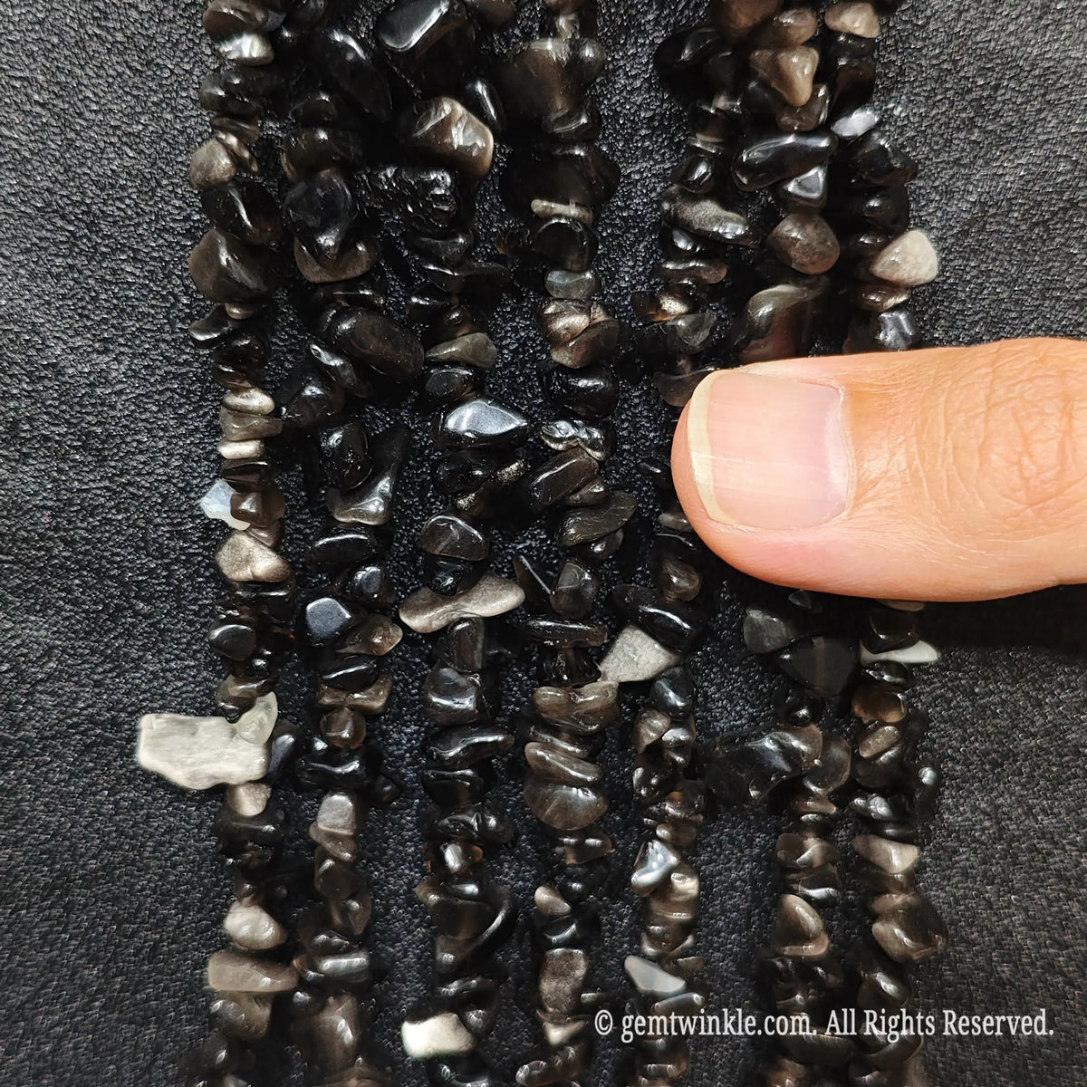 Silver Sheen Obsidian has a Mohs hardness of 5 to 5.5 and is a natural form of volcanic glass. To protect its polished surface and prevent scratches, avoid hard impacts, harsh chemical detergents, or ultrasonic jewelry cleaners. Clean gently with lukewarm soapy water and a soft cloth, and store separately in a soft cloth pouch.