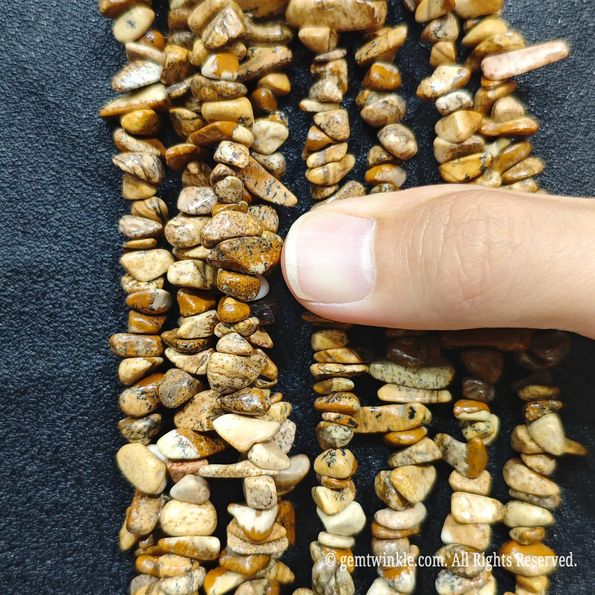 Detailed view of 75cm long natural wood grain jasper tumbled chipped gemstone strand for jewelry DIY