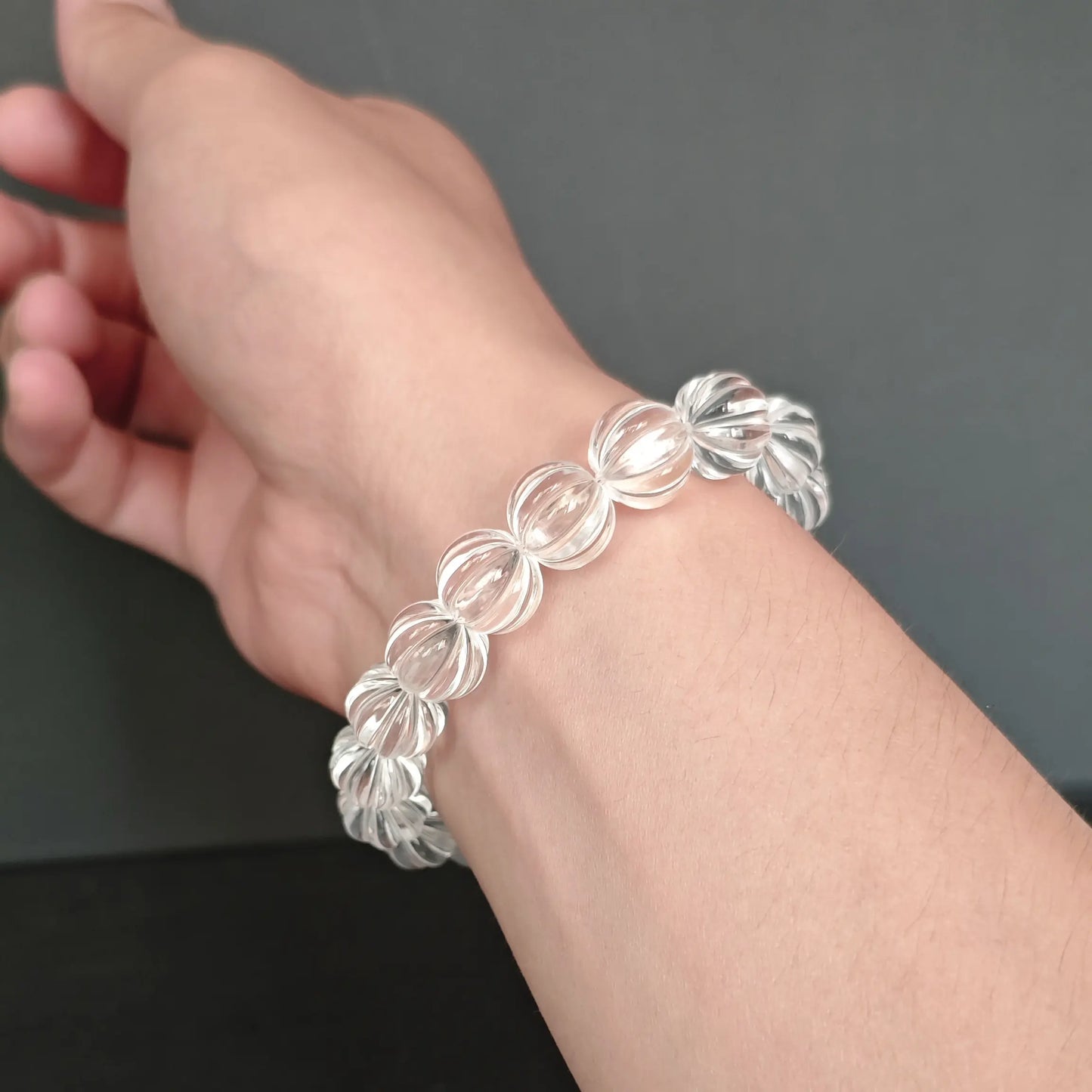 Clear quartz pumpkin bead bracelet worn on wrist, demonstrating stretchy elastic cord and elegant daily wear style