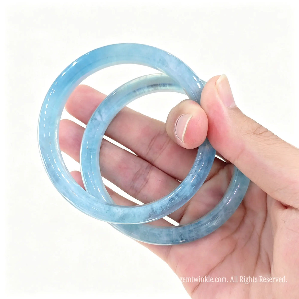 Natural Aquamarine bangles held together demonstrating crystal clarity and high gloss finish