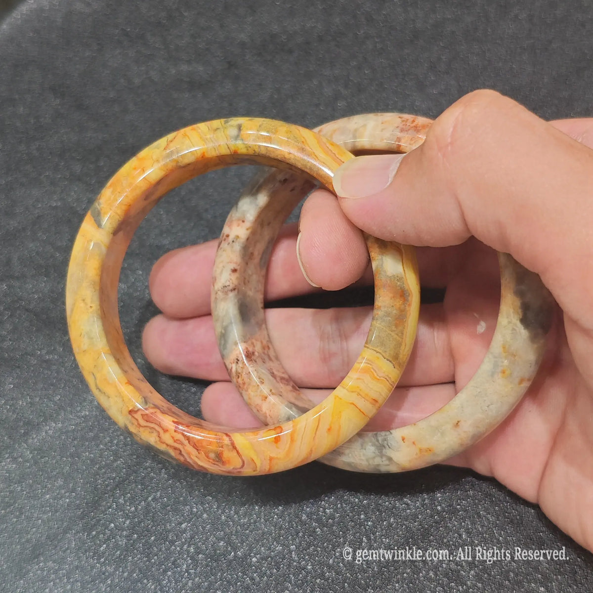 Natural Crazy Lace Agate bangles held together demonstrating genuine lace banding and high gloss finish