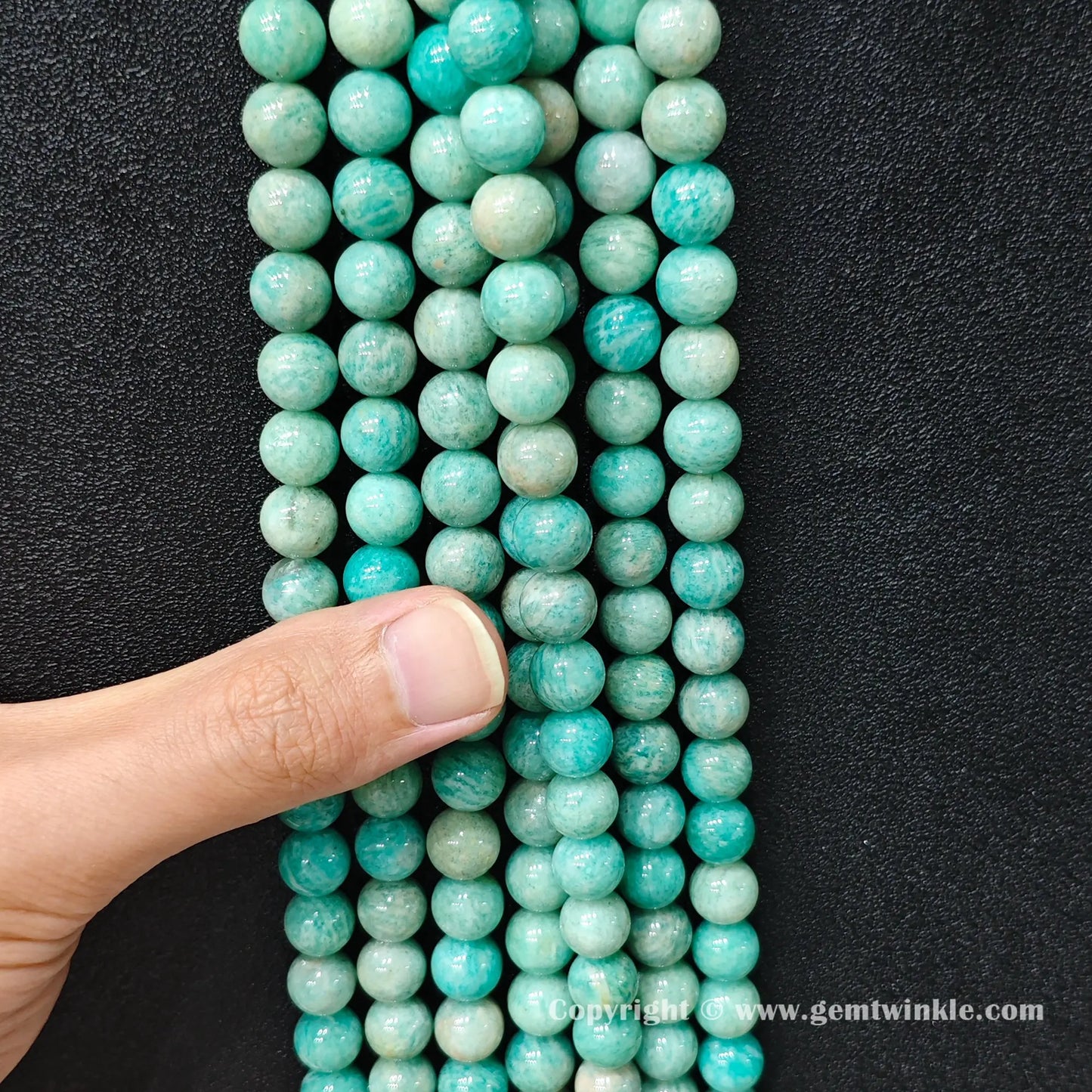 Parallel strands of Grade C natural amazonite beads showing organic mineral variance and scale
