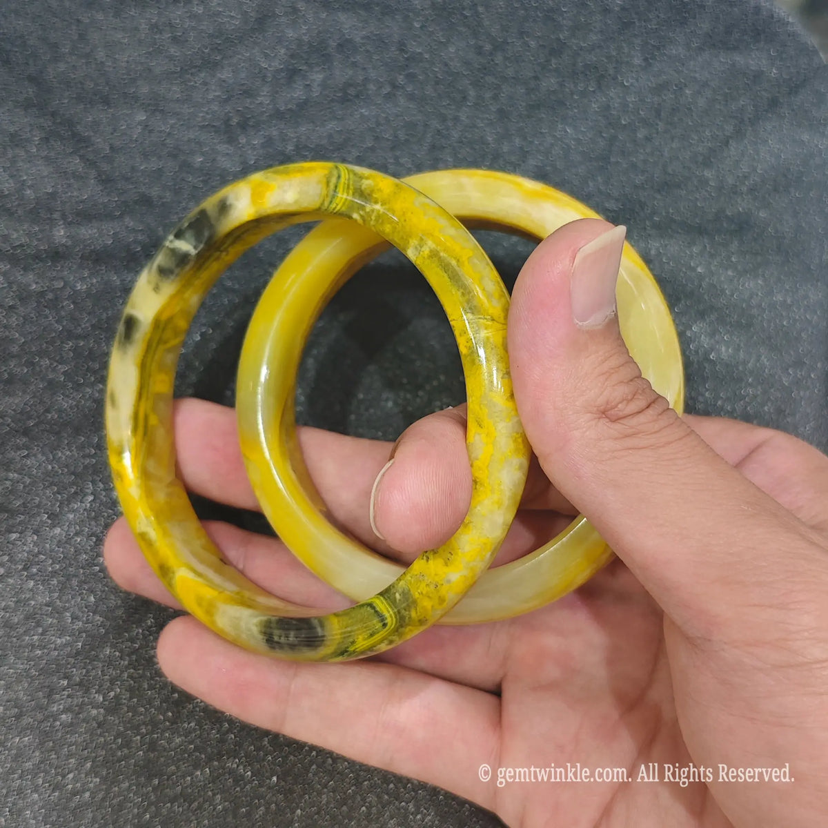 Natural Bumblebee Jasper bangles held together demonstrating unique natural rock banding in size range 56mm to 60mm