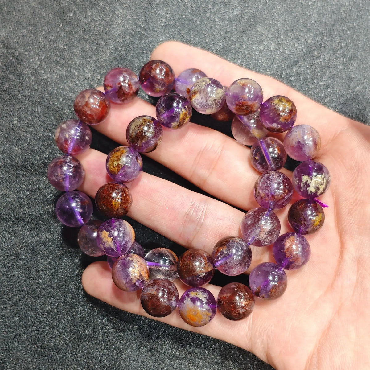 Double strand view of earthy purple garden quartz stretch wristlets held together displaying mineral inclusion variations