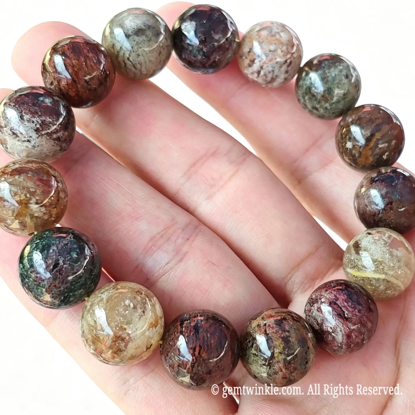 Four Seasons phantom quartz stretch bracelet displayed across fingers highlighting landscape inclusions and high clarity