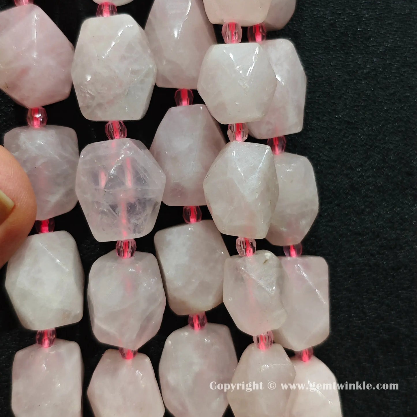 hand held scale preview of 18mm faceted rose quartz barrel beads