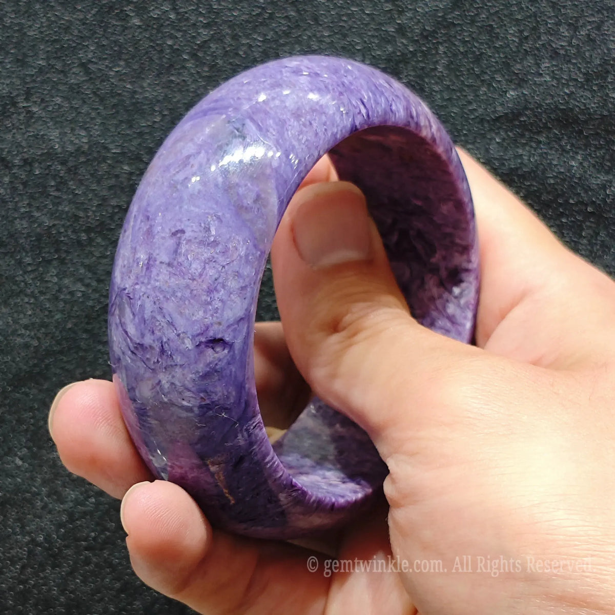 Charoite is a relatively delicate silicate mineral requiring thoughtful everyday care Clean gently using warm soapy water and a soft micro fiber cloth Avoid exposing your stone bangle to extreme heat harsh household chemicals or abrasive cleaning agents Store separately in a padded velvet pouch to prevent scratches from harder gemstones and remove before heavy physical activity