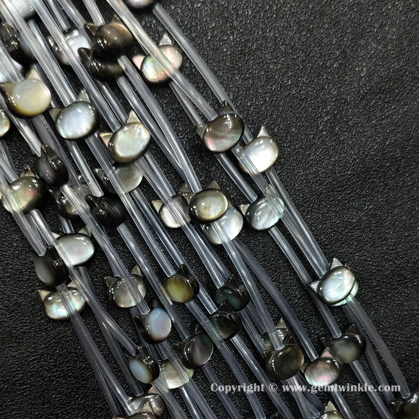 Handheld preview showing 6x7mm black shell kitty head beads in hand