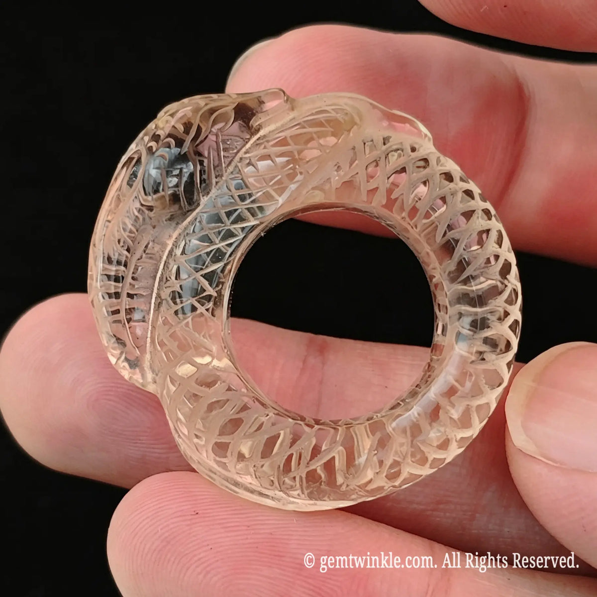 Hand preview of a carved lemon quartz snake ring showing translucent citrus color and solid gemstone band