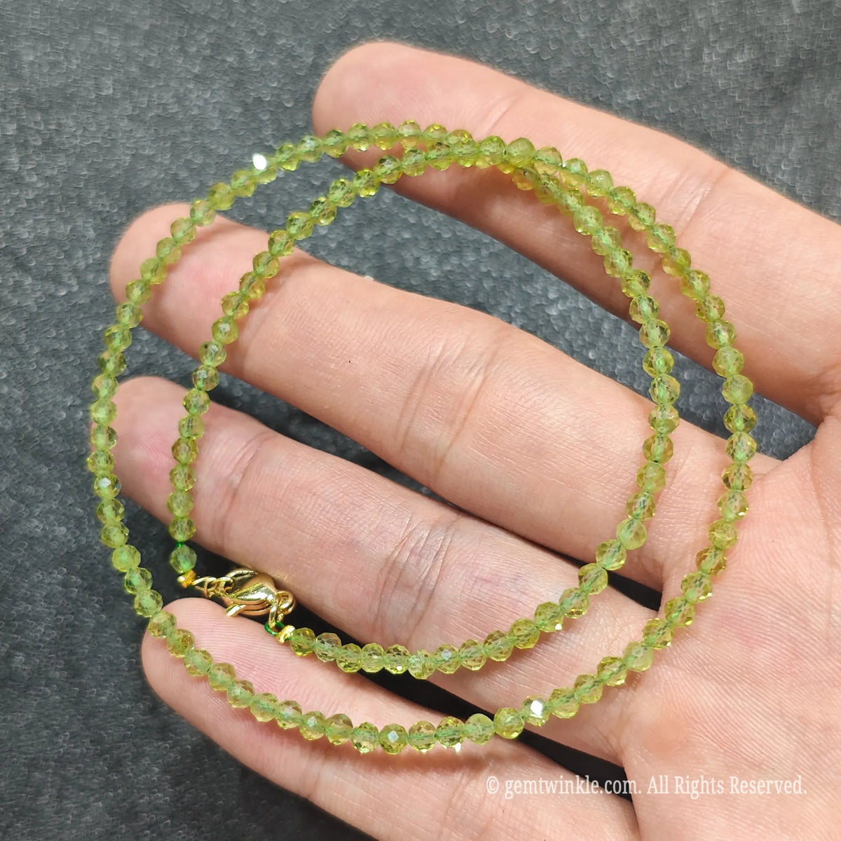 Detailed macro view of 3mm faceted peridot beads showing vibrant olive green tone and high vitreous clarity