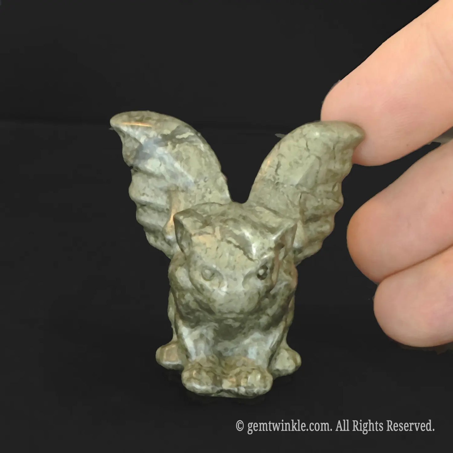 Front view of carved brassy gold pyrite gargoyle statue showing rich natural metallic luster