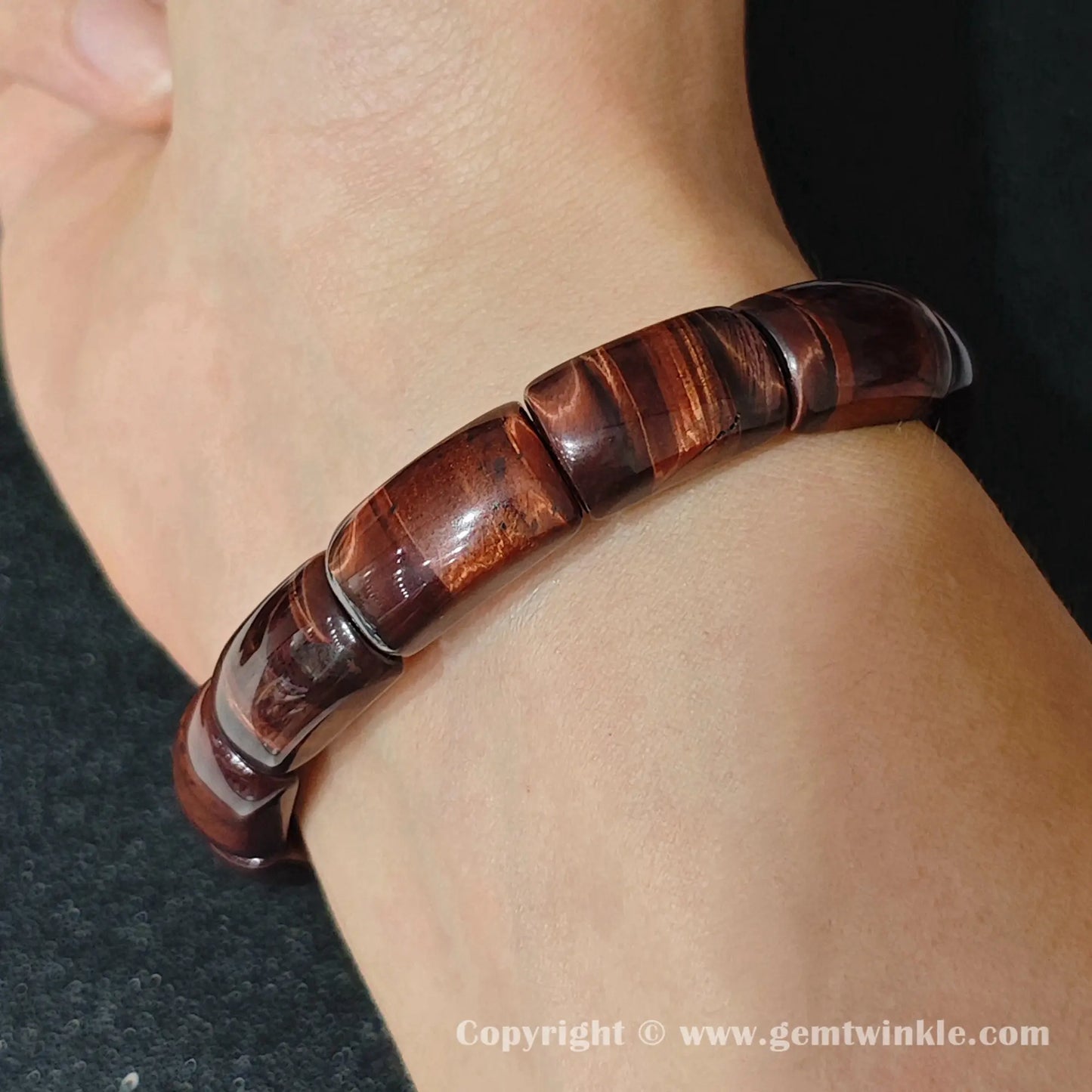 red tigers eye curved plate cuff bracelet worn on wrist showcasing elegant women fit and deep red luster