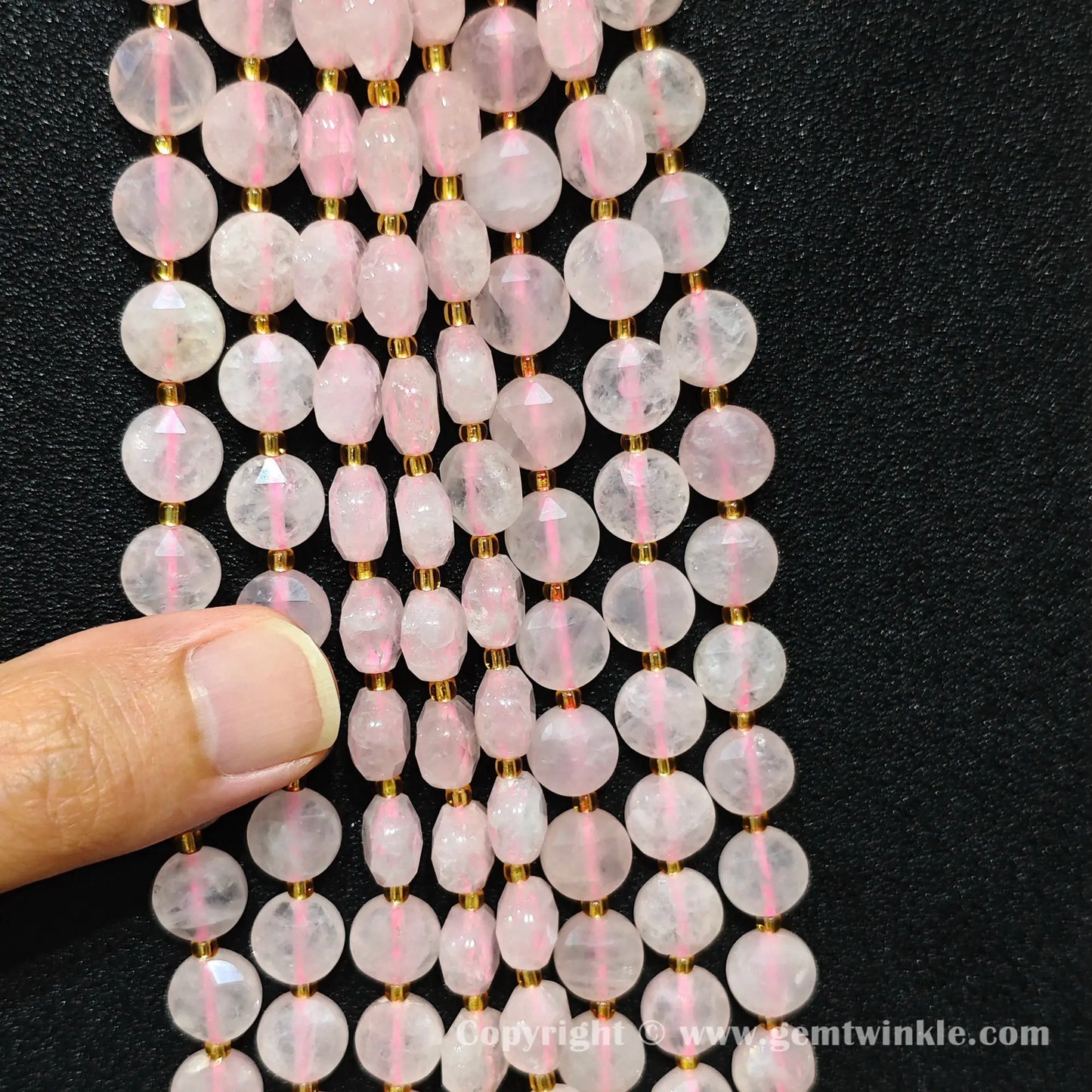Close up view showcasing bead alignment and stringing holes of rose quartz star beads