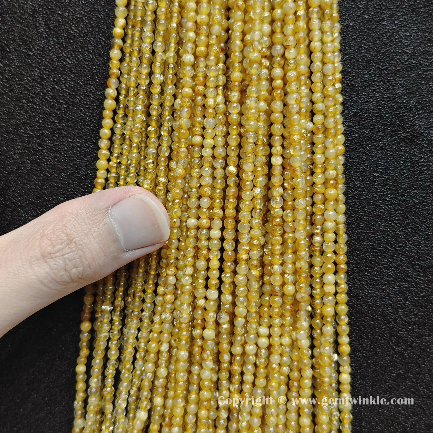 Bulk wholesale strands of B grade 3mm small round gold rutilated quartz loose beads with thick hair strands perfect for delicate stacking bracelets and fine jewelry making