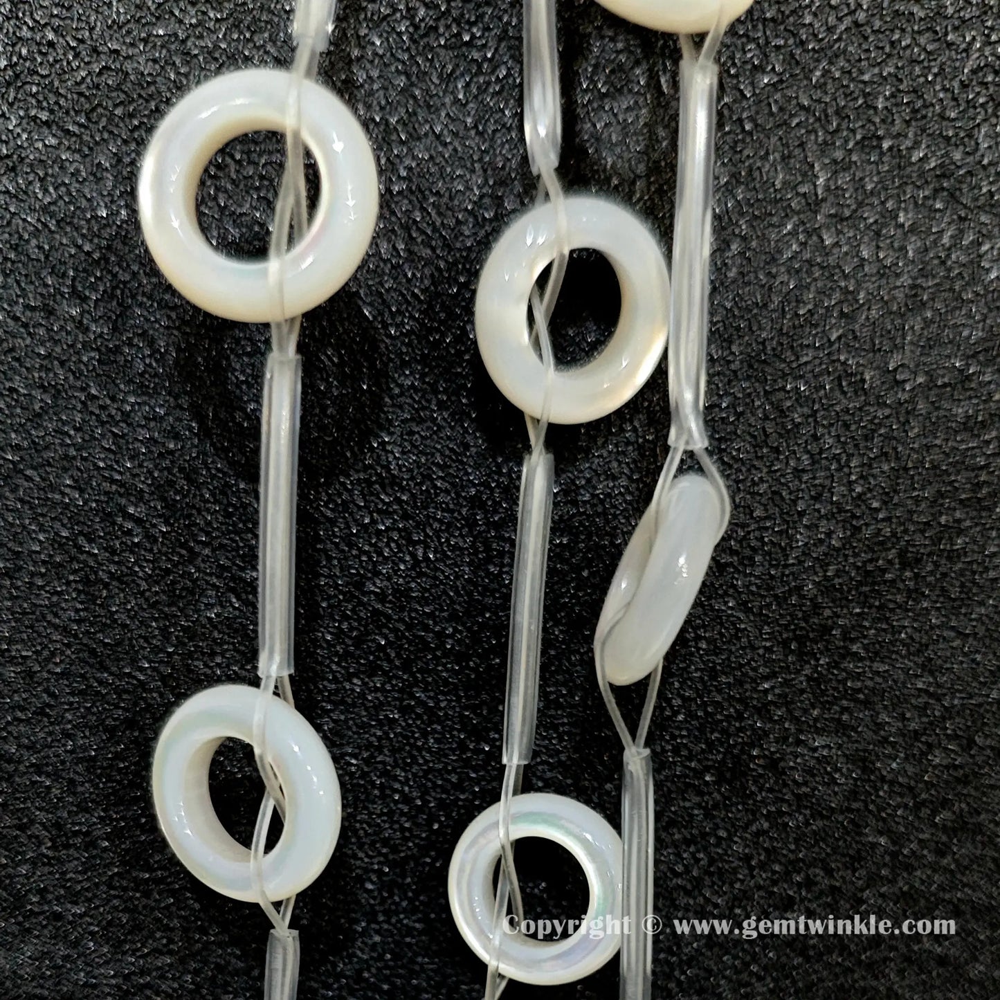 Handheld preview showing 14mm double sided laminated white shell ring beads