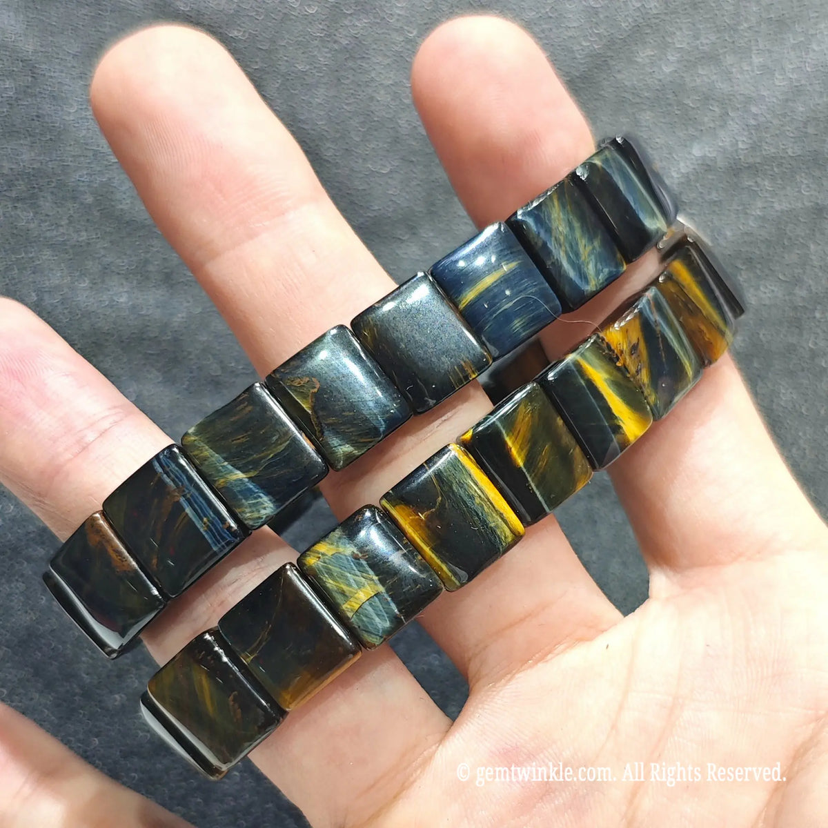Full view of a unisex blue yellow tiger eye gemstone band displayed on hand under studio lighting
