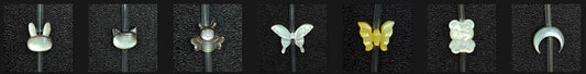 Assortment of precision-carved Mother of Pearl shell charms including bunny, cat, bee, butterfly, bear, and crescent moon shapes for jewelry making