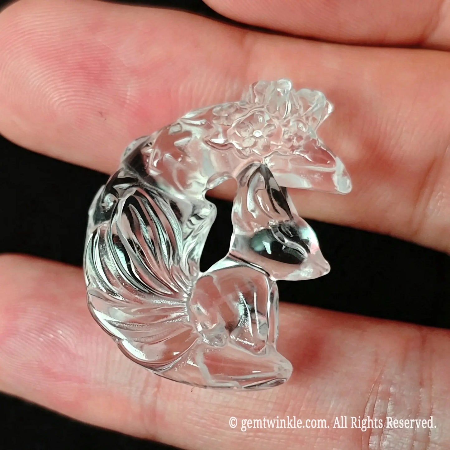Group preview of 30mm carved clear quartz fox on crescent moon pendants held in hand for jewelry making