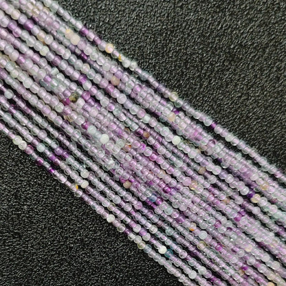 Close up of 3mm lavender purple fluorite beads micro crystal strands with natural cloudiness