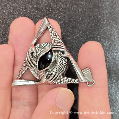 Handheld perspective showing 45mm dark obsidian triangle pendant with carved hand details