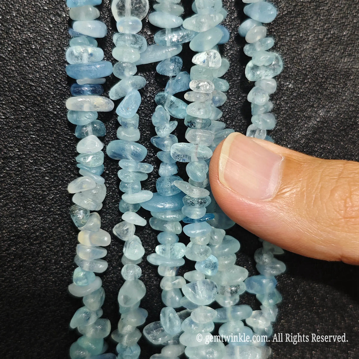 Detailed view of 75cm long acid-washed aquamarine tumbled chipped gemstone strand for jewelry DIY