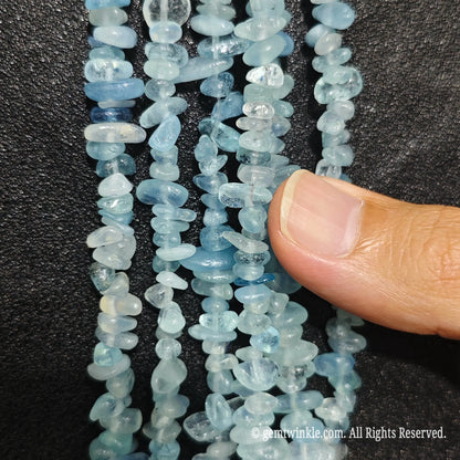 Detailed view of 75cm long acid-washed aquamarine tumbled chipped gemstone strand for jewelry DIY