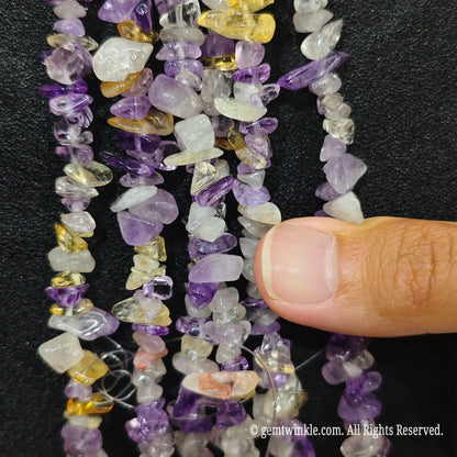 Detailed view of 75cm long natural amethyst and heat-enhanced citrine mixed tumbled chipped gemstone strand for jewelry DIY