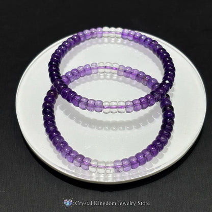 Two purple beaded bracelets on a white plate with a black background