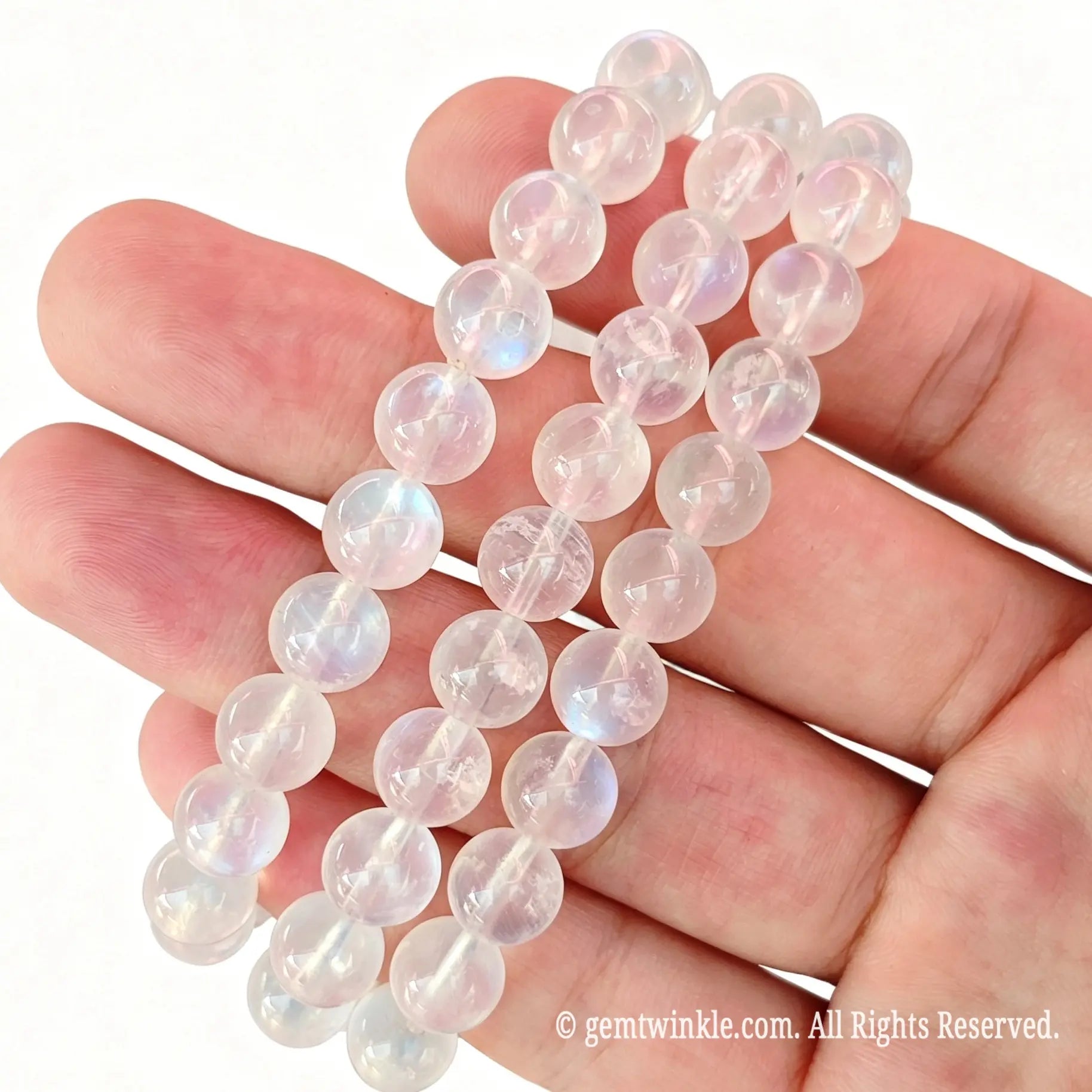 Close up preview of blue sheen moonstone bead strands highlighting smooth spherical polish