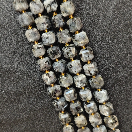 Close up of multi strands of natural black arfvedsonite soft-tumbled geometric cube beads showing overall strand layout