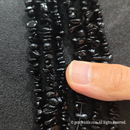 Detailed view of long 75cm natural black tourmaline chipped strand ready for DIY jewelry projects