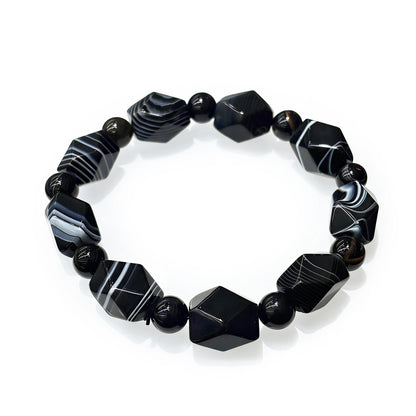Natural black and white banded agate irregular geometric bead bracelet on white background, statement self-love jewelry for women