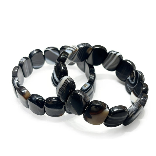 Natural black and white banded onyx geometric square bead bracelet on white background, minimalist wrist jewelry for women