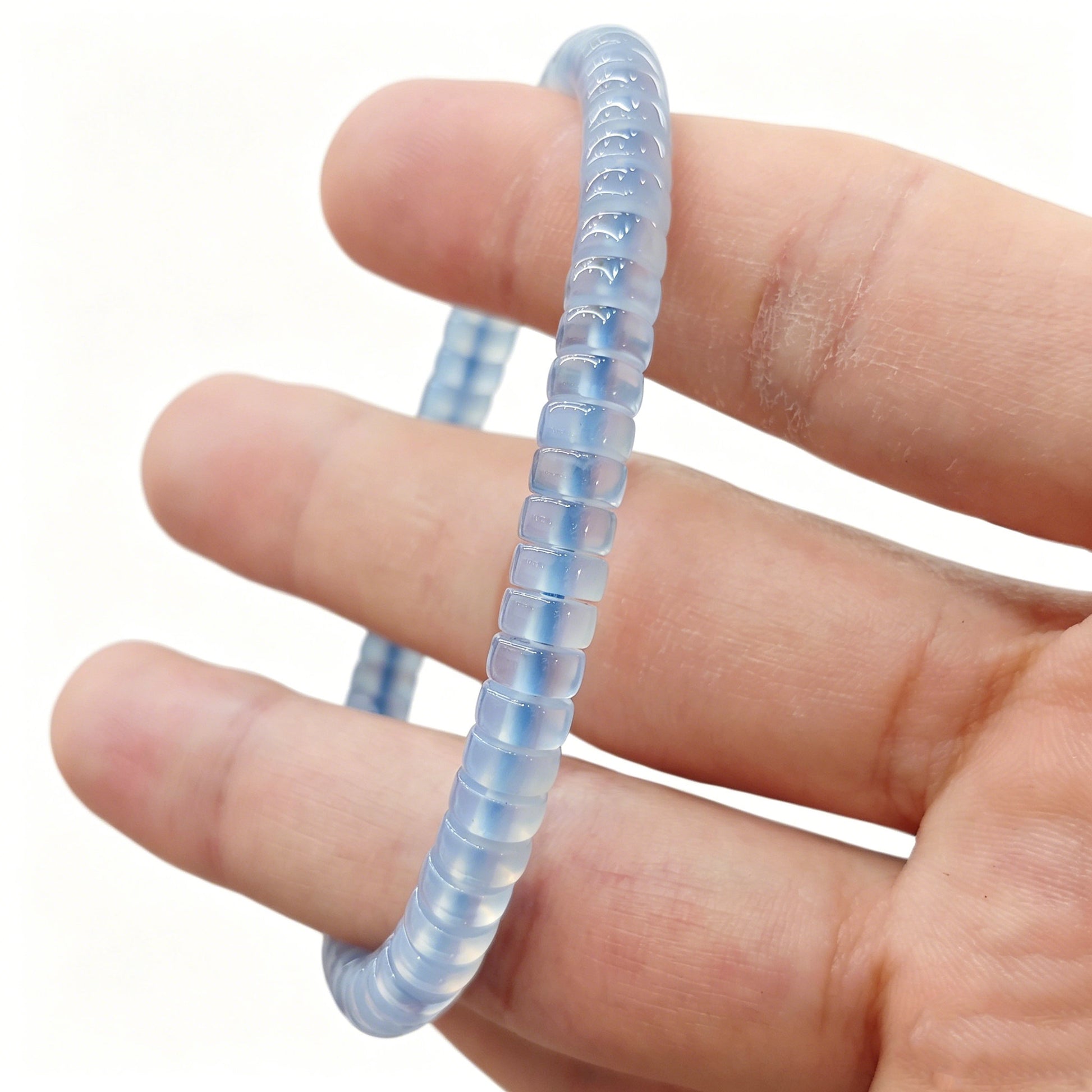 Serene sky blue agate tablet bracelet worn on wrist; gentle luster and calming tone visible under natural light