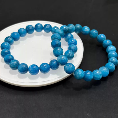 Collage of blue apatite bracelet worn on wrist in 4 settings: raised hand, side profile, close-up pose, street view — all on same model