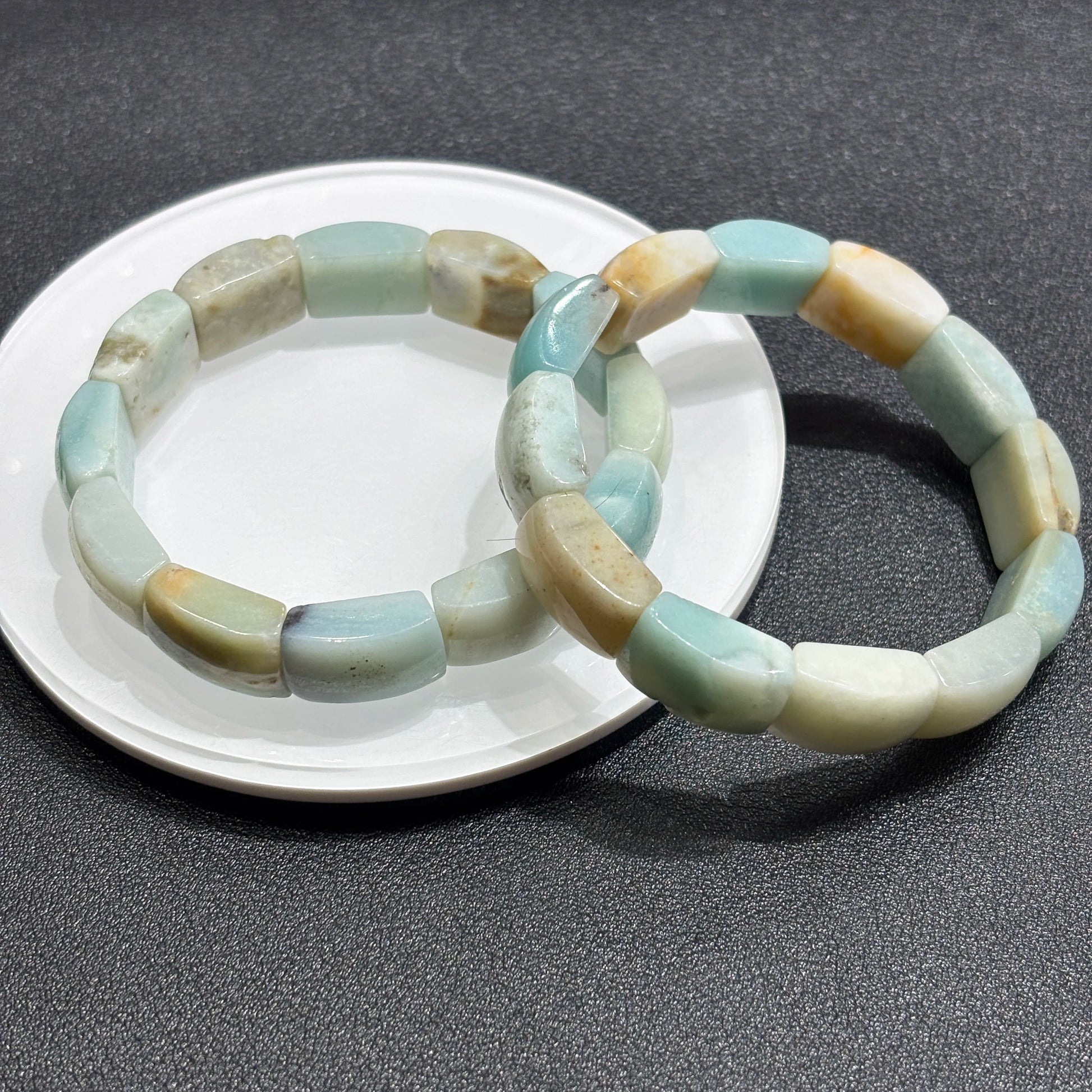 Two natural caribbean calcite square bead bracelets layered on white ceramic plate; highlights pastel palette and clean lines