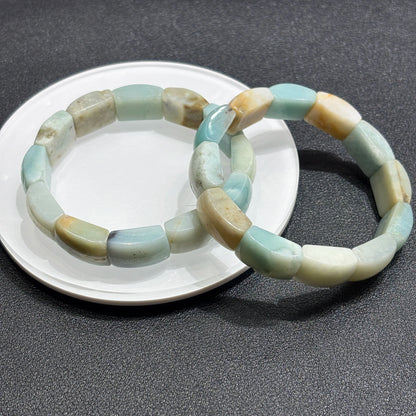 Two natural caribbean calcite square bead bracelets layered on white ceramic plate; highlights pastel palette and clean lines