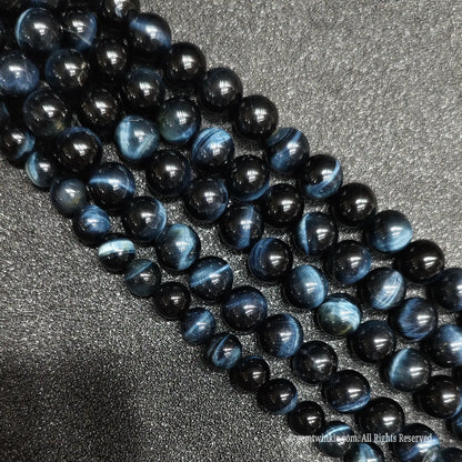 Polished blue tigers eye loose gemstone strands showing natural silky mineral fibers