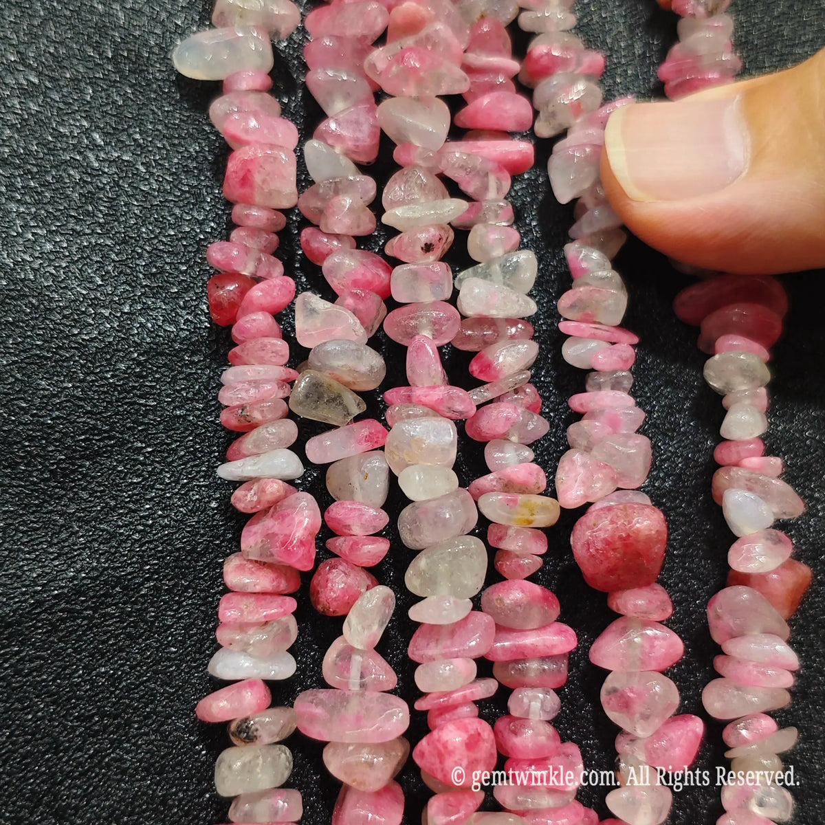 Detailed view of long 75cm natural sakura agate chipped strand ready for DIY jewelry projects