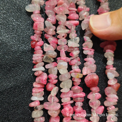Detailed view of long 75cm natural sakura agate chipped strand ready for DIY jewelry projects