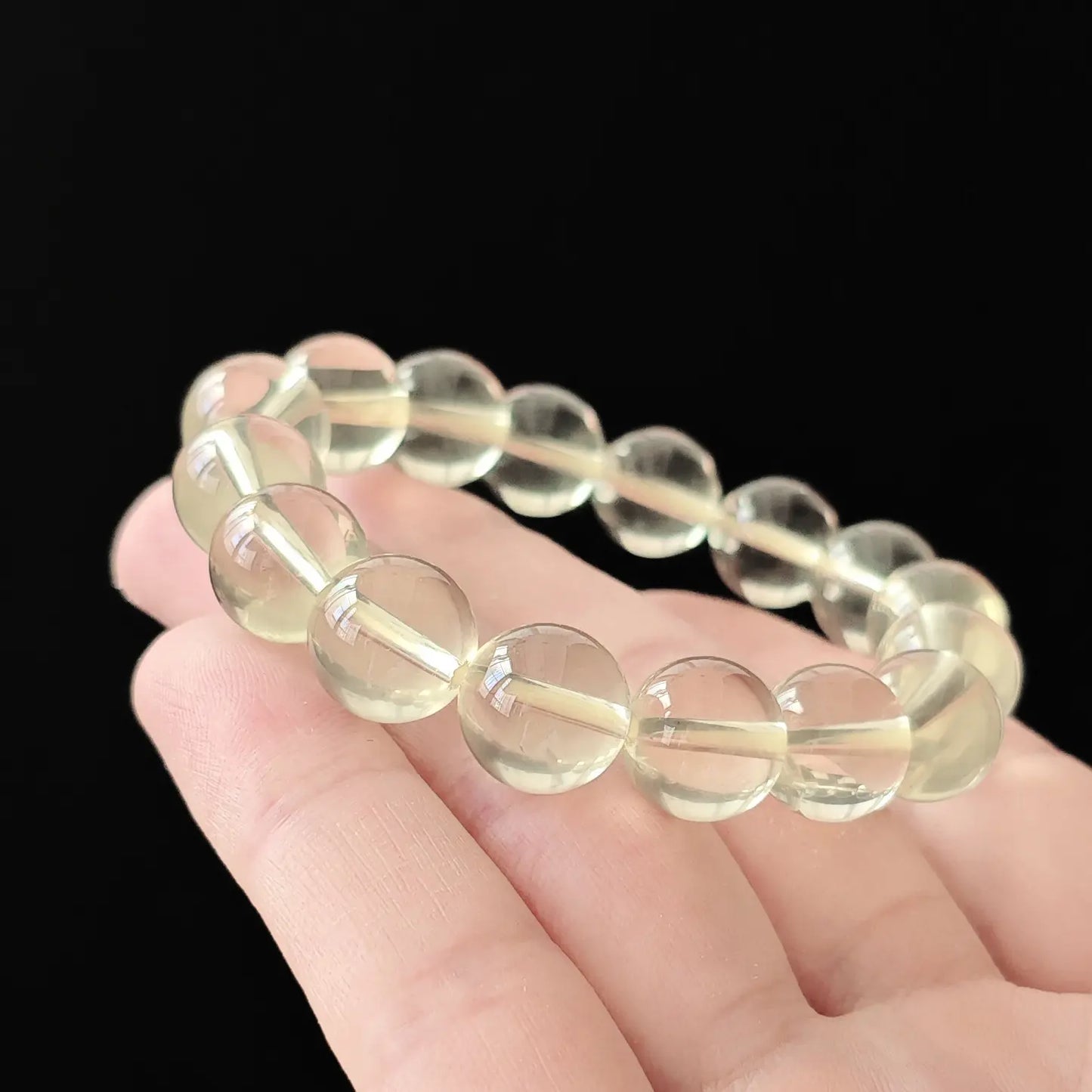 Citrine round beads gently curved—demonstrating stretch comfort, even spacing, and clean transparency