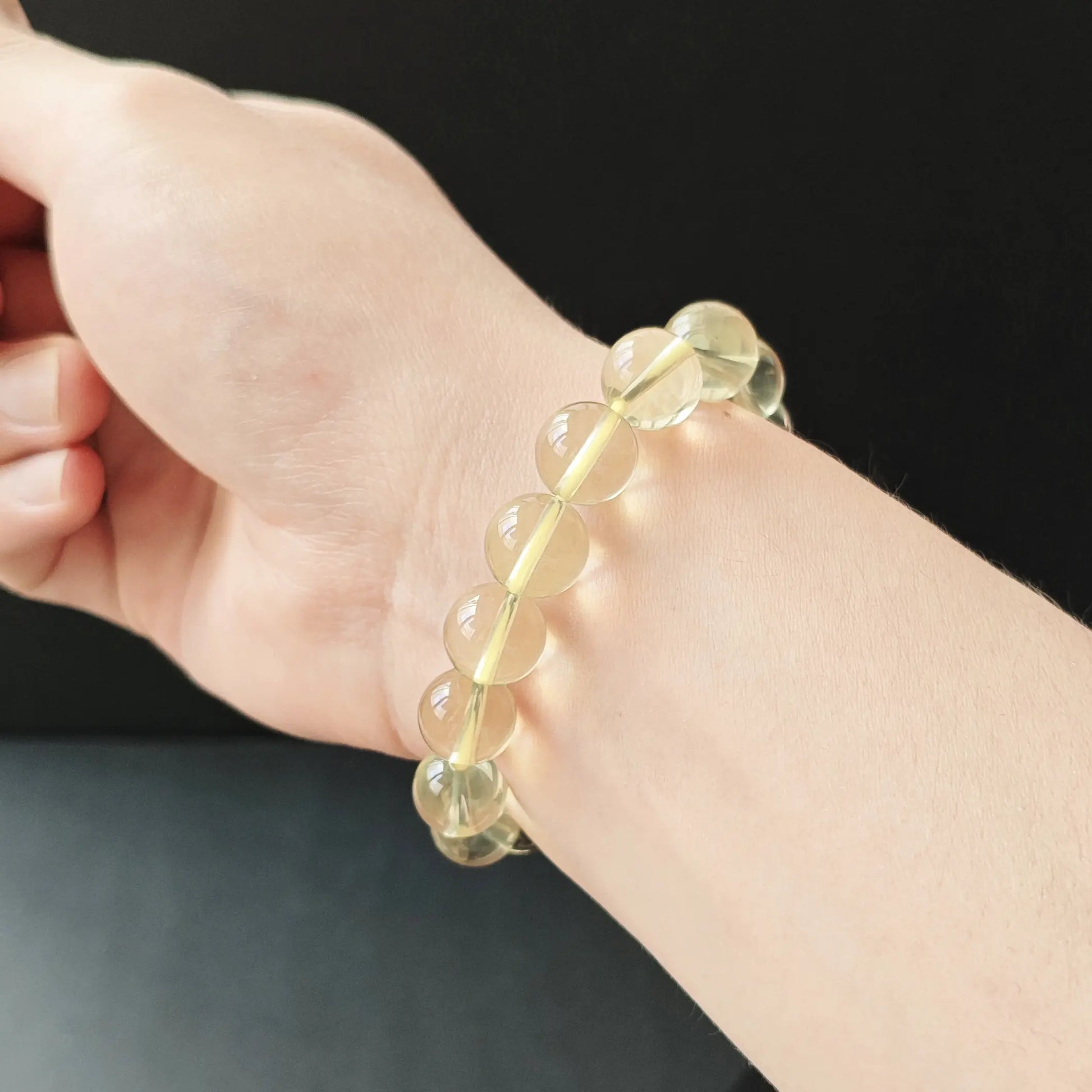 Light citrine round bracelet on wrist—subtle glow, comfortable drape, ideal for layering or solo wear