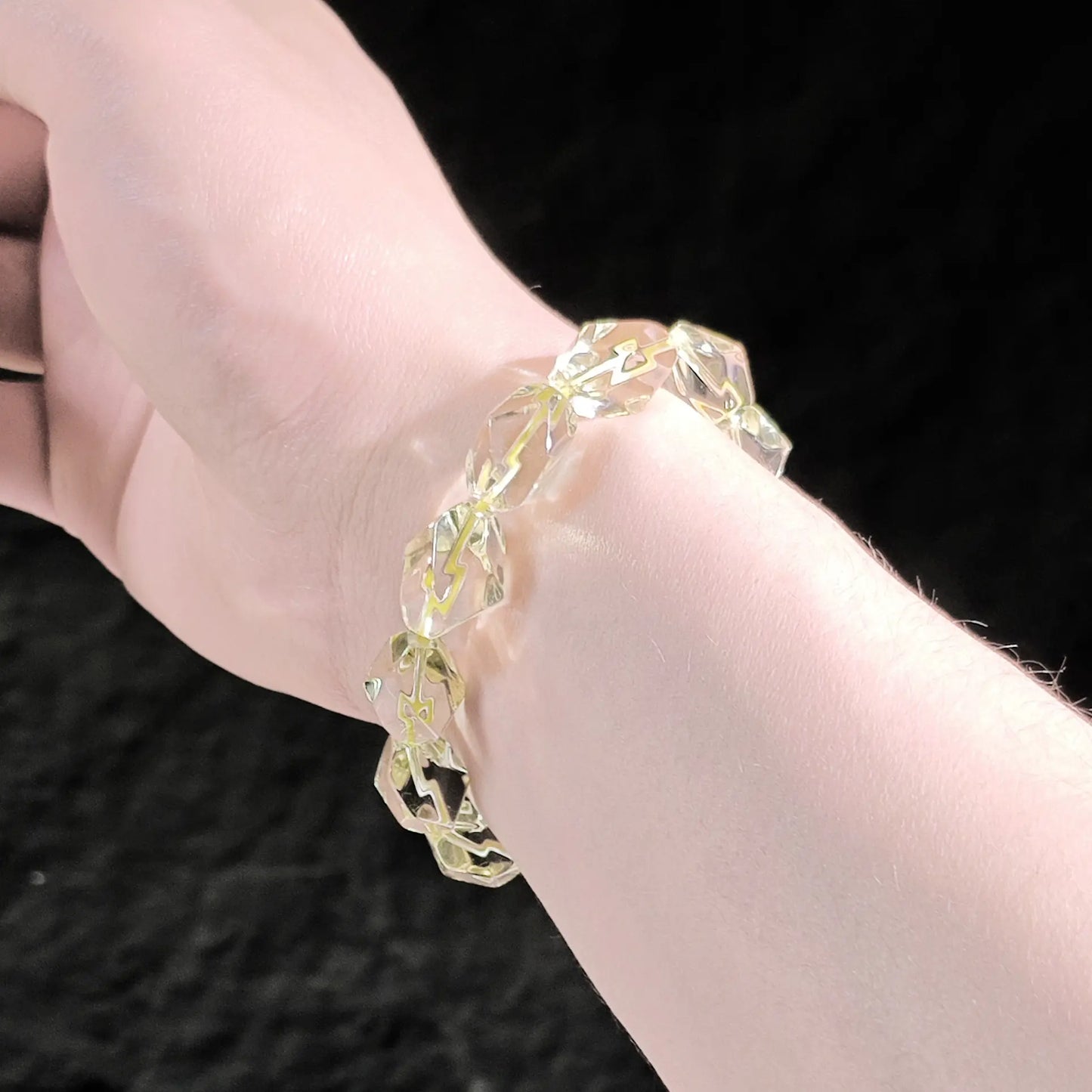 Lemon yellow citrine faceted bracelet worn on wrist; warm glow and subtle sparkle visible under natural light